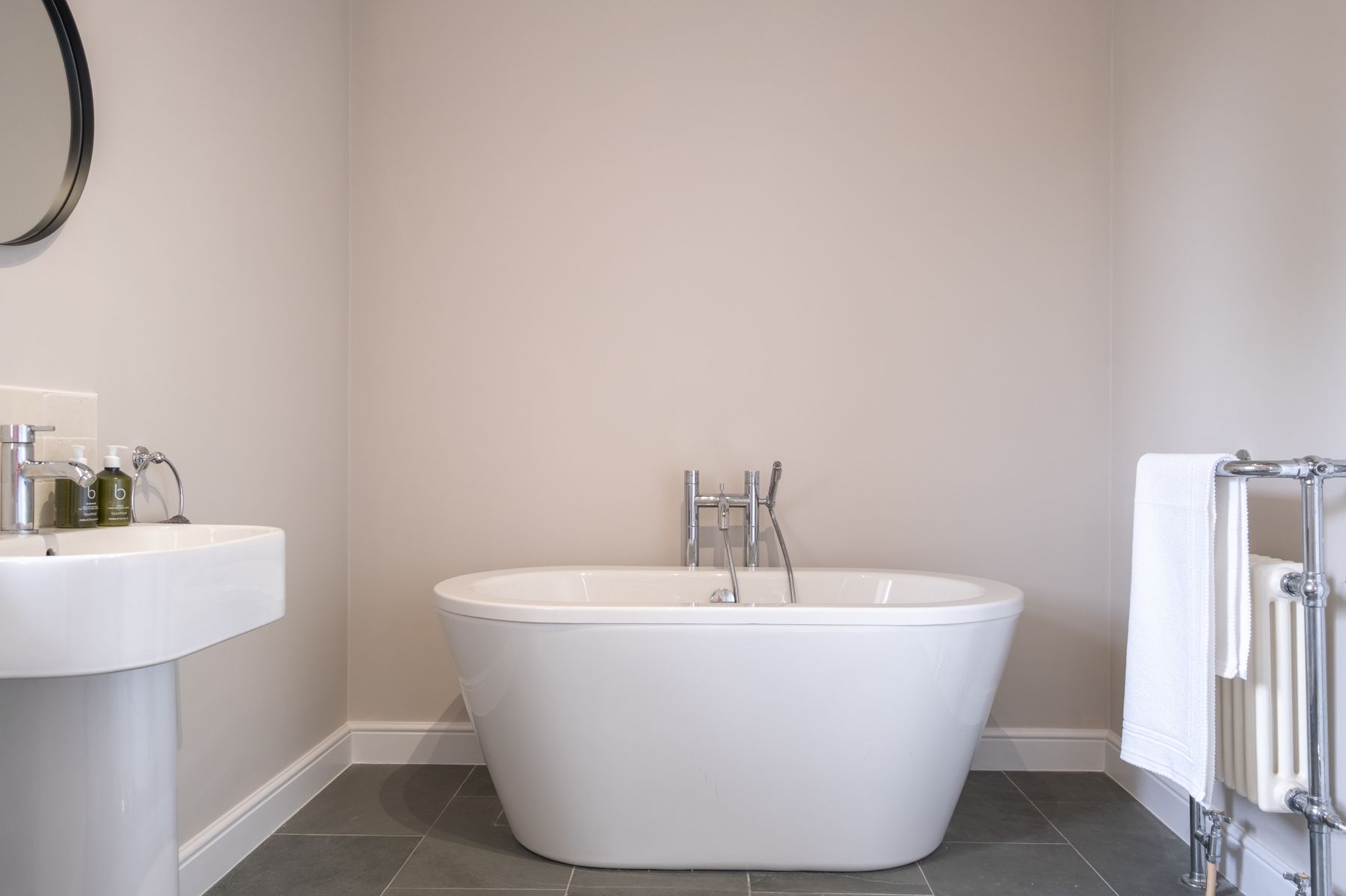 The second bathroom, with a freestanding bath on a slate floor