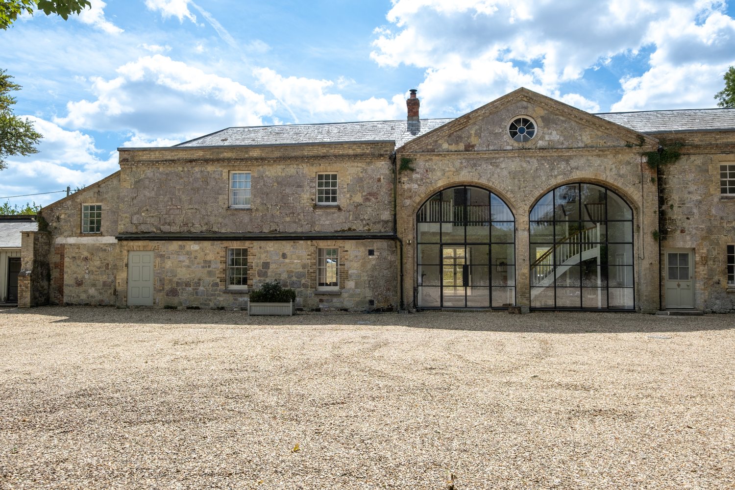 The Coach House and its courtyard, with the two arched Crittall windows